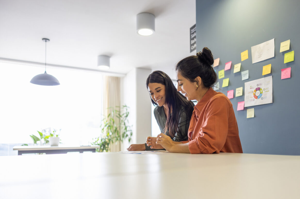 Latin American business women working together at a coworking office